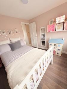 a bedroom with a large white bed and a staircase at Marlow Family Retreat, Short Stroll into Town in Marlow