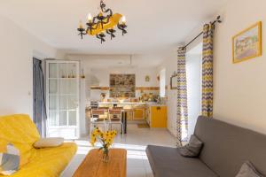a living room with a couch and a table at Chez l'Oncle in Larnas