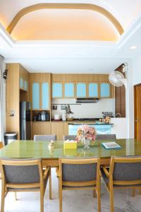 a dining room with a table and chairs at The Tropical Pool Villas Ao Nang Group Krabi in Ao Nang Beach +122 photos
