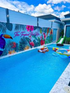 a swimming pool with a mural on the wall at The Tropical Pool Villas Ao Nang Group Krabi in Ao Nang Beach