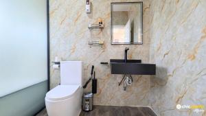 a bathroom with a toilet and a sink at Chic & spacious studio with parking in Yaoundé +6 photos