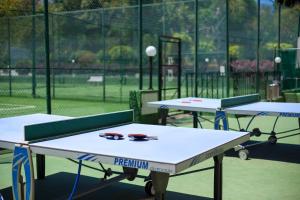 three ping pong tables on a tennis court with sunglasses on them at Apartamentos Masaru in Puerto de la Cruz