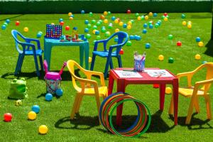 a group of chairs and a table in the grass at Apartamentos Masaru in Puerto de la Cruz