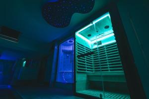 a dark room with a window with blue lights at Loft Spa Sauna Hammam Hydromassage in Reims