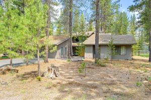 a house in the woods with a yard at 14 Mt Hood Lane home in Sunriver