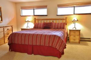 a bedroom with a bed and two windows at Pet Friendly 8 Leisure Home in Sunriver +14 photos