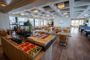 a restaurant with a buffet in the middle of a room at Hótel Laugarbakki in Laugarbakki
