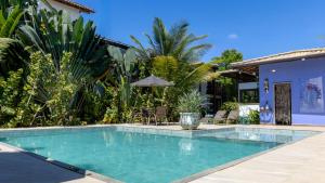 a swimming pool in front of a house at Taipu Bay Pousada - Taipu de Fora in Barra Grande