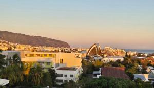 a view of a city with buildings and the ocean at Appartement moderne et élégant in Saint-Denis