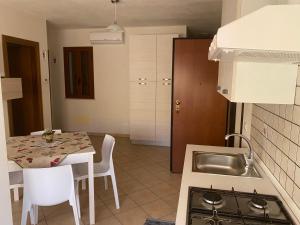 a kitchen with a sink and a table with chairs at Casa Madonie Isnello in Isnello