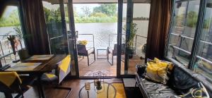 a living room with a view of the water at Tiny Hanzeboat in Hattem