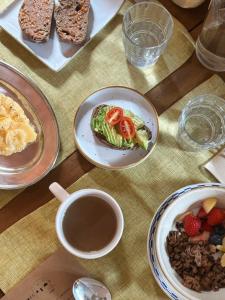 a table with plates of food and a cup of coffee at Casa Merceditas in Corsá