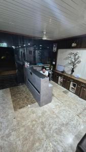 a person sitting at a counter in a room at Hotel dhola maru in Kota