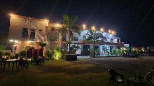 a large building with lights on it at night at Hotel dhola maru in Kota