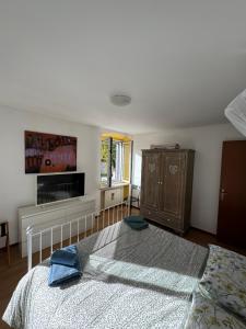a bedroom with a bed and a dresser at Al vecchio convento, centro storico in Gorizia