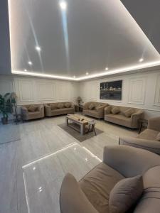 a large living room with couches and a table at شاليه الإطلالة فخم ووسط الرس in Al Rass