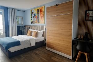 a bedroom with a bed and a large wooden door at Hotel Parc & Lac in Montreux