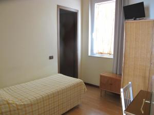 a hotel room with a bed and a window at Hotel Conchiglia in Montecatini Terme
