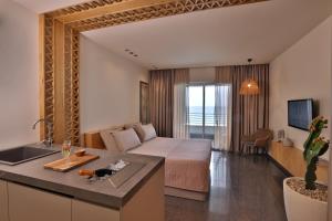 a hotel room with a bed and a sink at OCEAN BLUE HOTEL & RESORT -Jbeil in Jbeil