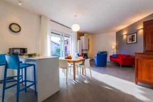 a kitchen and living room with a table and chairs at Casa Augusta in Verbania