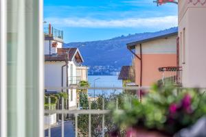 a view of a lake from a street with buildings at Casa Augusta in Verbania
