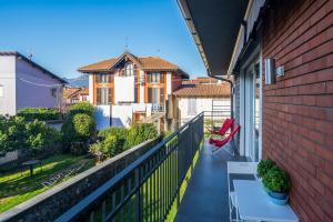 a balcony with a table and a view of a house at Casa Augusta in Verbania