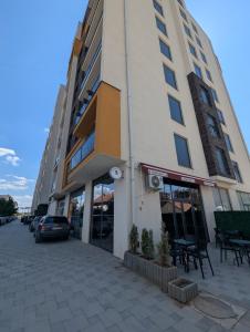 a building with a car parked in front of it at Studio Soft Hue in Kosovo Polje