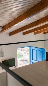 a kitchen with blue cabinets and a view of a patio at Alex & Sofi Hotel in Himare