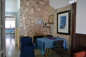ein Esszimmer mit einem Tisch und einer Steinwand in der Unterkunft Casa Urbana in Villa Progreso