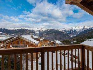 a view from the balcony of a lodge with snow covered mountains at Chalet neuf, spacieux et moderne, en plein cœur de Courchevel Village, proche des pistes, 14 couchages - FR-1-562-1 in Courchevel