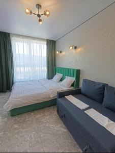 a bedroom with a bed and a couch at Стрийська Автовокзал Арена Львів in Lviv
