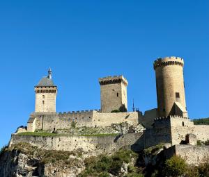 a castle on a hill with two towers at L'Ariane, Vue sur le château in Foix