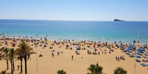 a crowd of people on a beach with umbrellas at Levante Frontline Luxury Duplex 5 Bedrooms in Benidorm +18 photos