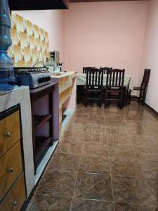 a kitchen with a counter and chairs in a room at Hospedaje Santa Rita in Zacatlán