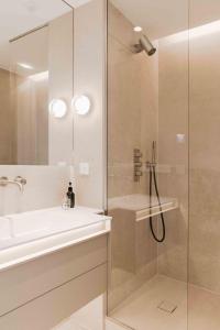 a bathroom with a shower and a sink and a glass shower stall at Vue de l'Océan à la forêt, la plage à vos pieds in Soorts-Hossegor +37 photos
