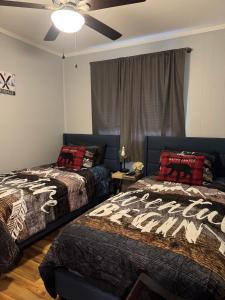 a bedroom with two beds and a ceiling fan at Beech Mountain Getaway in Beech Mountain +25 photos