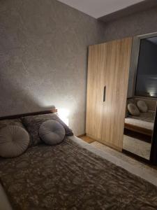 a bedroom with a bed with two pillows and a cabinet at Apartament z tarasem Zeta Park in Ustroń