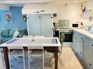 a kitchen with a table and chairs in a room at 2 Bedroom Cottage - Sleeps 6 - Pool - Garden in Caylus