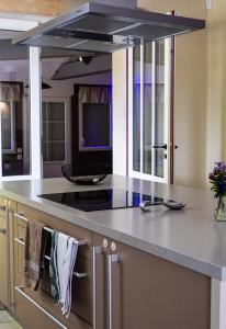 a kitchen with a island with a stove top at Charme & Sens Avec Jacuzzi intérieur in Thésée
