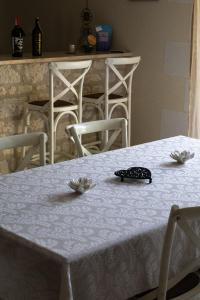a table with a white table cloth and a phone on it at Charme & Sens Avec Jacuzzi intérieur in Thésée +19 photos