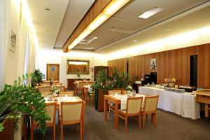 a dining room with tables and chairs in a restaurant at Hotel Maxim in Tvrdošín