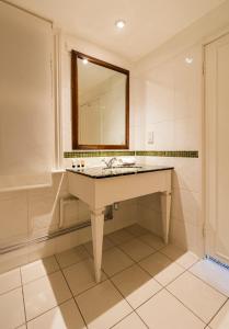 a bathroom with a sink and a mirror at The Old Ship Hotel- Part of the Cairn Collection in Brighton & Hove
