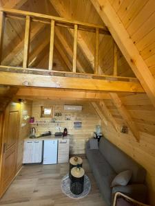 an attic room with a couch and a kitchen at Lake house angela in Kuside