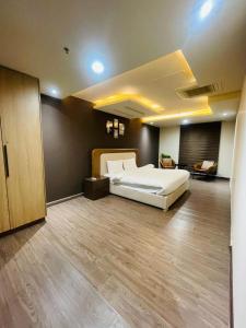 a bedroom with a large bed in a room at Luxury suites in Lahore +3 photos