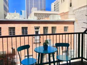 a table and chairs on a balcony with a building at Loft Retreat - King Bed&Balcony - Pet-Friendly 30 in Denver