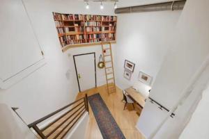 a room with a book shelf on the wall at Loft Retreat - King Bed&Balcony - Pet-Friendly 30 in Denver