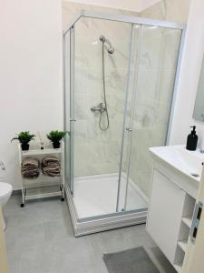 a shower with a glass door in a bathroom at RxM HOME CITY in Chiajna