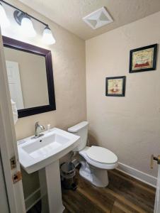 a bathroom with a toilet and a sink and a mirror at Starfire 1992 by SummitCove Lodging in Keystone