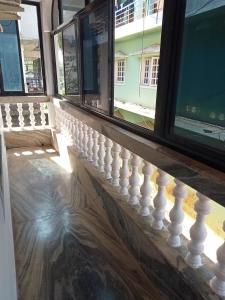 a balcony with white railings and windows at Morni Home's morjim in Morjim