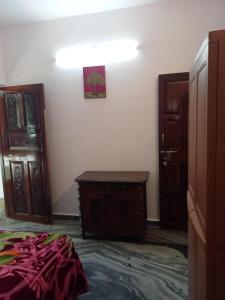 a bedroom with a bed and two wooden doors at Morni Home's morjim in Morjim